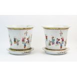 A pair of Chinese porcelain famille rose jardinieres and stands, each of cylindrical form and
