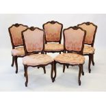A set of eight Louis XV style walnut framed dining chairs, each with a shell carved crest above a