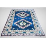 A blue ground hand woven Turkish Karis carpet, 198cm x 131cm