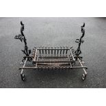 An early 20th century Arts and Crafts cast iron fire basket with andirons, cast with stylised dragon