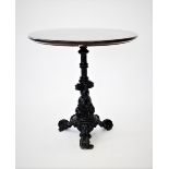 A Victorian cast iron pub table, the circular hardwood top raised upon a cast fluted pedestal