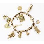 A 9ct gold charm bracelet, the bracelet comprising mixed curb-links and trombone links with spring-