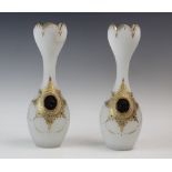 A pair of opaque glass vases, 20th century, with baluster form bodies and tapering tulip form necks,