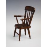 A late 19th century model of a farmhouse Windsor chair, probably an apprentice piece, the chair