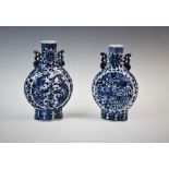 A matched pair of Chinese porcelain moon flasks, 19th century, the circular bodies with dragon