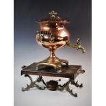 A William IV copper samovar, of ogee vase form upon a quatreform plinth base with leafy scroll toes,