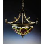 An early 20th century Tiffany style light fitting, of circular domed form, decorated in floral
