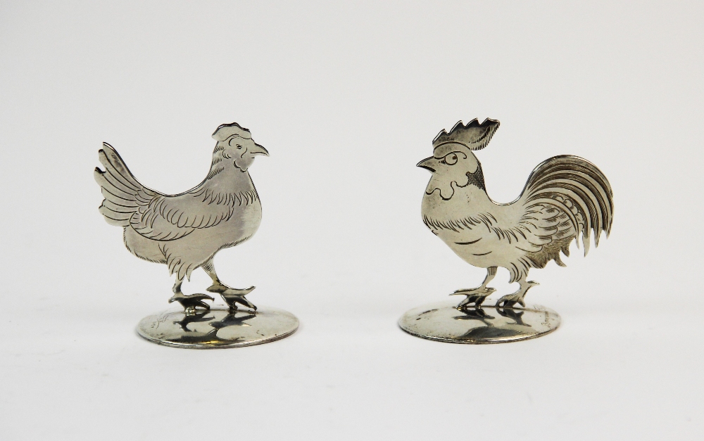 A pair of silver place card holders, Sampson Mordan & Co Ltd, Chester 1912, one designed as a