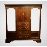 A 1920's Chinese Chippendale revival mahogany compactum wardrobe, with a dentil cornice above a