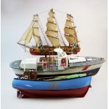 A modern remote controlled model of a coast guard boat, 70cm long, upon a hardwood stand, with a