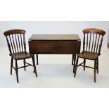 An 18th century oak drop leaf kitchen table, the rectangular plank top raised upon tapering