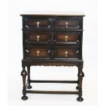 A 1920's oak Jacobean revival chest on stand, with a rectangular moulded top above three graduated