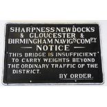 A cast iron railway sign, cast in relief with painted white text upon a black ground, 'New dock &