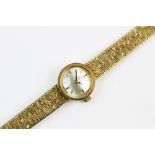 A lady's vintage Omega 9ct gold wristwatch, the round pearlescent dial with baton markers, set to