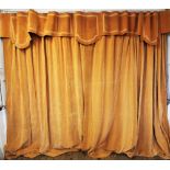 A set of three mid 20th century curtains, designed with velour material in an apricot palette,