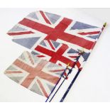 A vintage Union Jack flag, 171cm x 114cm , along with two smaller examples, 80cm x 55cm, all mounted