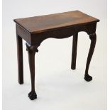 A George III mahogany side or console table, the rectangular top above a serpentine apron, raised