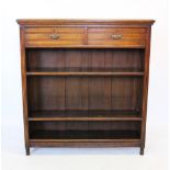 An Edwardian oak open bookcase, with a rectangular moulded top above two frieze drawers and two