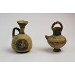 A Cypriot Geometric period Bichrome ware pottery jug, decorated in umber and crimson with concentric