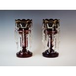 A pair of Victorian glass bohemian lustres, of typical form, with scalloped rims, the cranberry