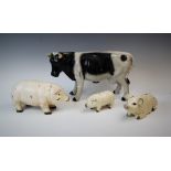 A group of three novelty piggy banks, 20th century, each with cold painted metal body, modelled