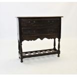 A George III oak dresser base of small proportions, the rectangular moulded and cross banded top
