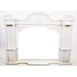 An Edwardian painted overmantle mirror, with central arched pediment above the arched bevelled