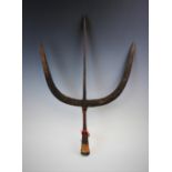 A primitive African/Middle Eastern iron trident, the central arrowhead prong flanked by curved