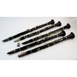 A collection of five early 20th century and later rosewood coloured clarinets, Excelsior Sonorous