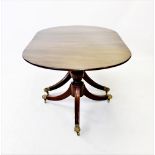 A Regency style mahogany twin pedestal dining table, early 20th century, the oval top with reeded