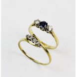 A three-stone diamond and sapphire ring, the central round mixed cut sapphire approx. 4mm, with a