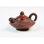 A Chinese Yixing terracotta teapot, decorated with a stylised dragon, removable cover with pierced