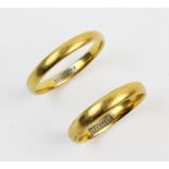 Two 22ct gold wedding bands, both with plain polished exterior with 'fidelity' engraved to interior,