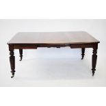 A Victorian mahogany extending dining table, the rectangular moulded top with rounded corners, above