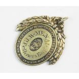 A Pitt Club gilt badge, c.1810, of oval form, set with laurel wreath surround, with engraved motto