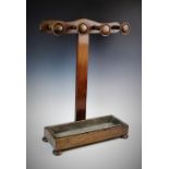 A Victorian mahogany stick stand, later constructed, of 'T' form, the cupids bow top rail applied