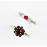 A garnet floral cluster 9ct gold ring, comprising nine mixed cut garnets claw set in yellow gold