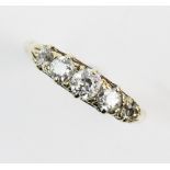 A five stone diamond ring, comprising five graduated round old cut diamonds, claw set in yellow