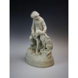 A Parian ware figural group, early 20th century, modelled as a boy feeding a dog, seated on a