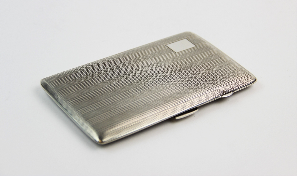 A silver cigarette case, John Rose, Birmingham 1943, of rectangular form, with striped and engine - Image 3 of 3