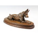 A bronze model of a recumbent hound, 20th century, modelled laying on an oak plinth base, 40cm wide