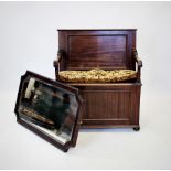 An early 20th century mahogany box settle, with a panelled back above down swept arms and a hinged