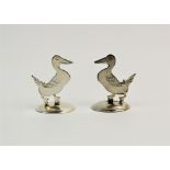 A pair of silver place card holders, Sampson Mordan & Co Ltd, Chester 1912, each modelled as a