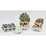 A pair of Derby porcelain fox and hen candlesticks, circa 1770, each modelled with a seated fox