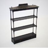 A 19th century black Japanned hanging wall shelf, with a pagoda type canopy above three shelves