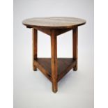 A 19th century elm and pine cricket table, the circular elm top raised upon three pine angled legs