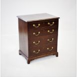 A George III mahogany commode chest, the rectangular hinged top above four faux drawers applied with