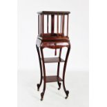 An Edwardian inlaid mahogany revolving bookcase on stand, the square moulded top centred with an