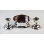 A silver mounted wine coaster London 2000, with turned oak base, 12.5cm diameter with a pair of