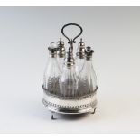 A George III silver cruet, London 1786, the circular stand raised on three ball and claw feet with